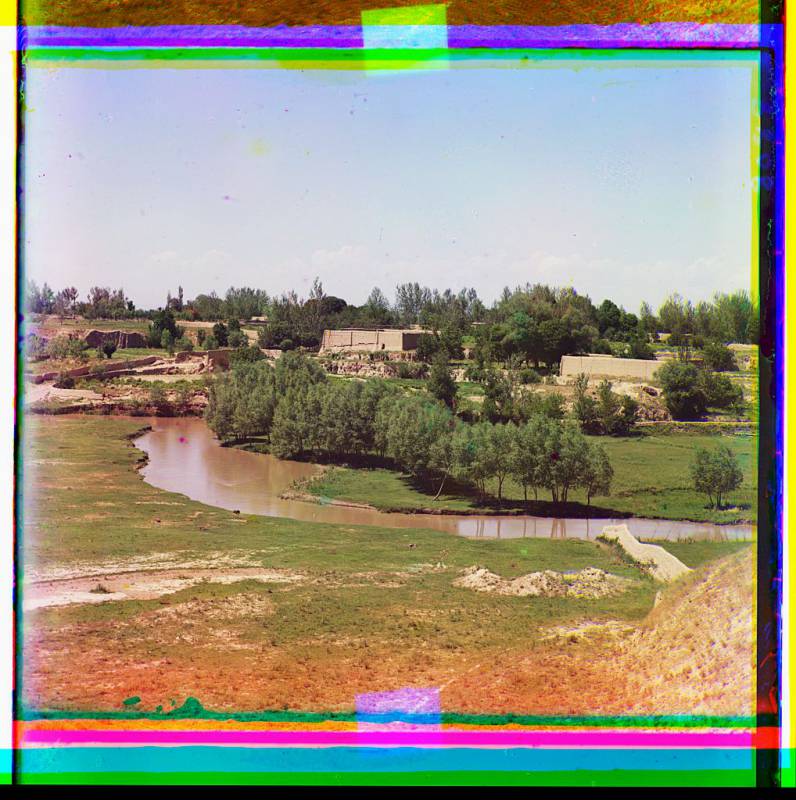 adobe_buildings_along_a_vegetated_stream.jpg