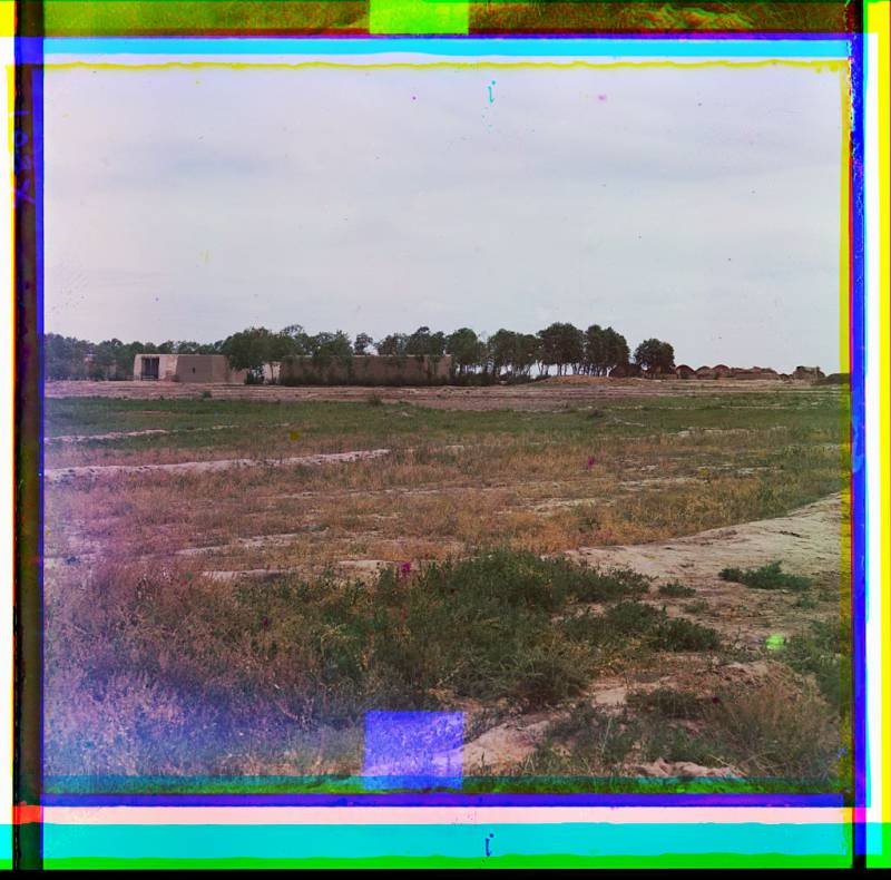 adobe_buildings_and_yurts_field_in_foreground_trees_in_background.jpg