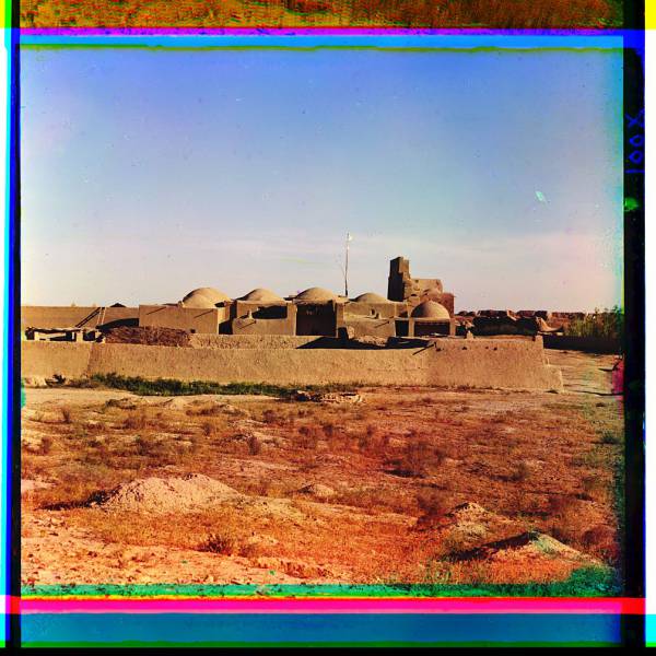 domed_adobe_structures_surrounded_by_an_adobe_wall.jpg