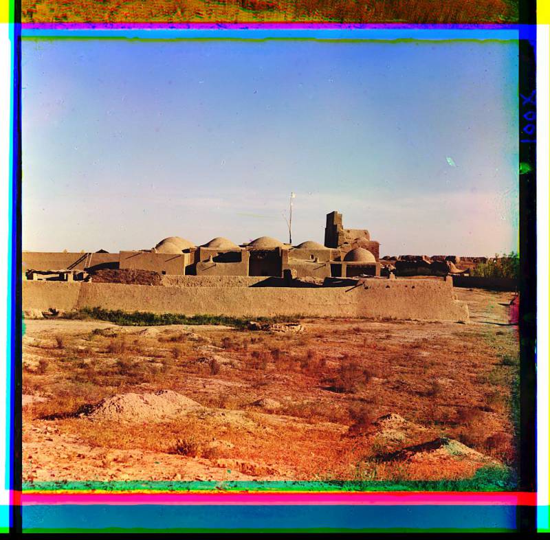 domed_adobe_structures_surrounded_by_an_adobe_wall.jpg