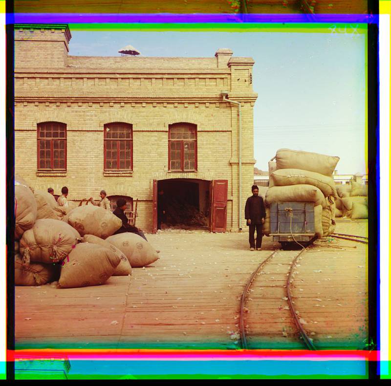 laborers_loading_sacks_onto_railway_at_factory_warehouse.jpg