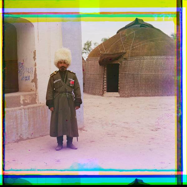man_in_uniform_beside_building_yurt_in_background.jpg