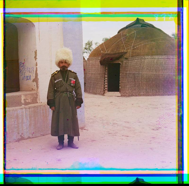 man_in_uniform_beside_building_yurt_in_background.jpg