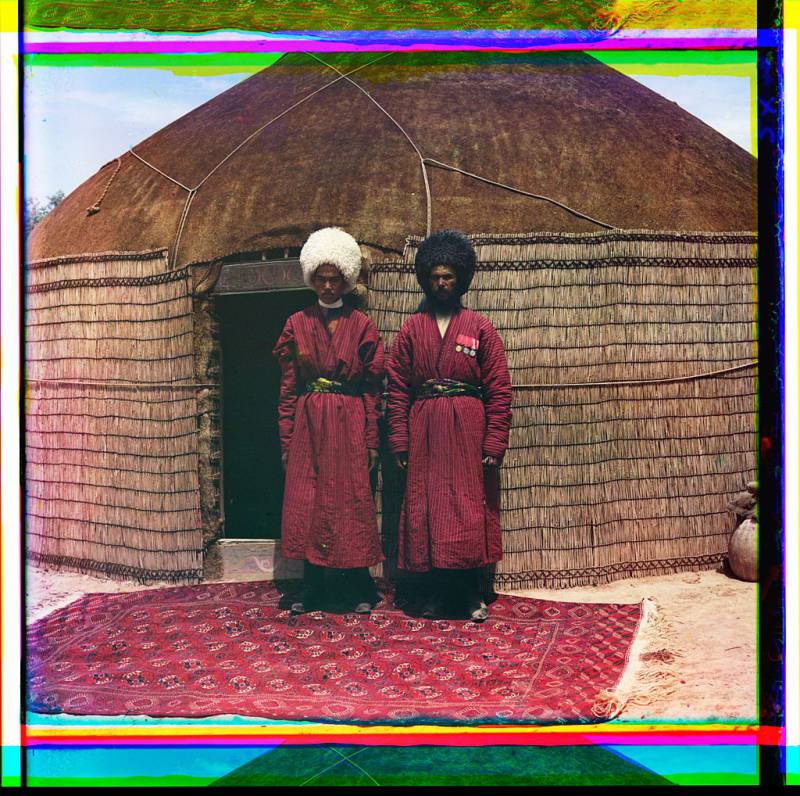two_men_standing_on_a_rug_in_front_of_yurt.jpg