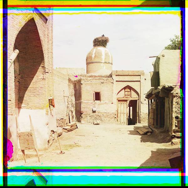 view_of_a_courtyard_adobe_buildings_and_a_bird_s_nest_atop_a_dome..jpg