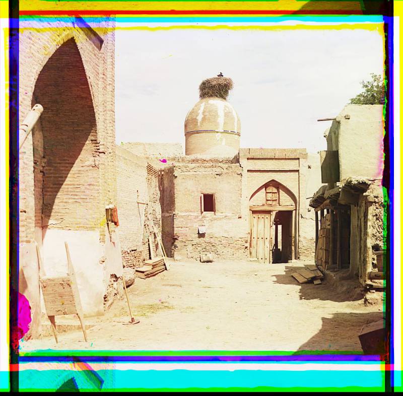 view_of_a_courtyard_adobe_buildings_and_a_bird_s_nest_atop_a_dome..jpg