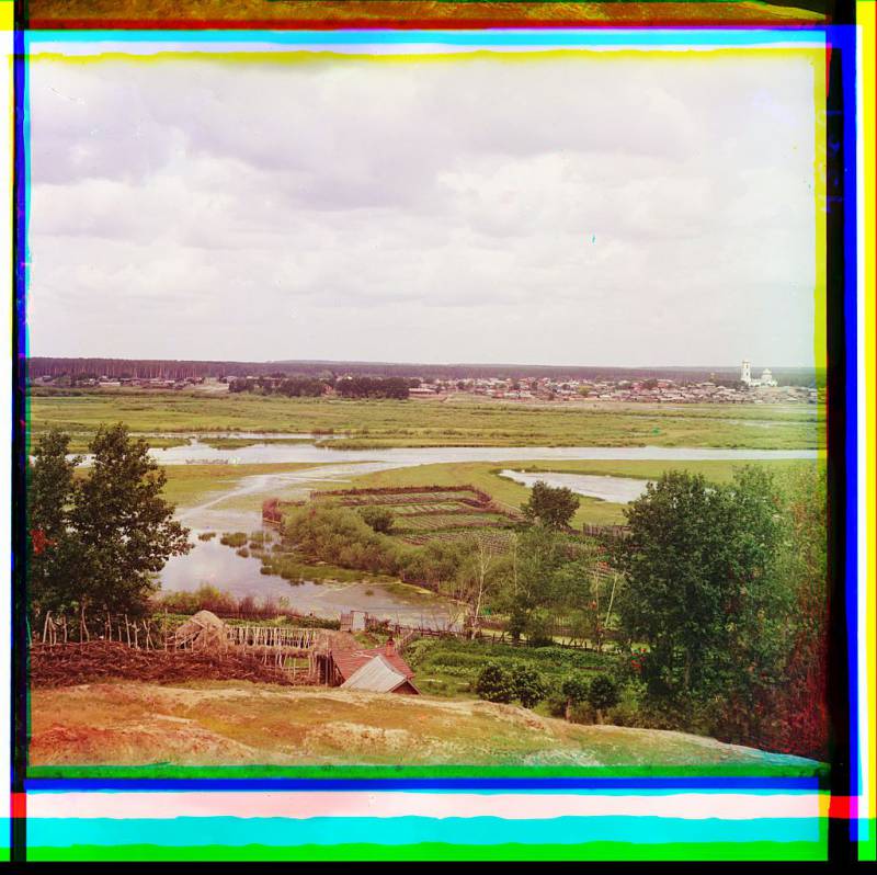 view_of_a_settlement_croplands_and_a_forest_near_a_river..jpg